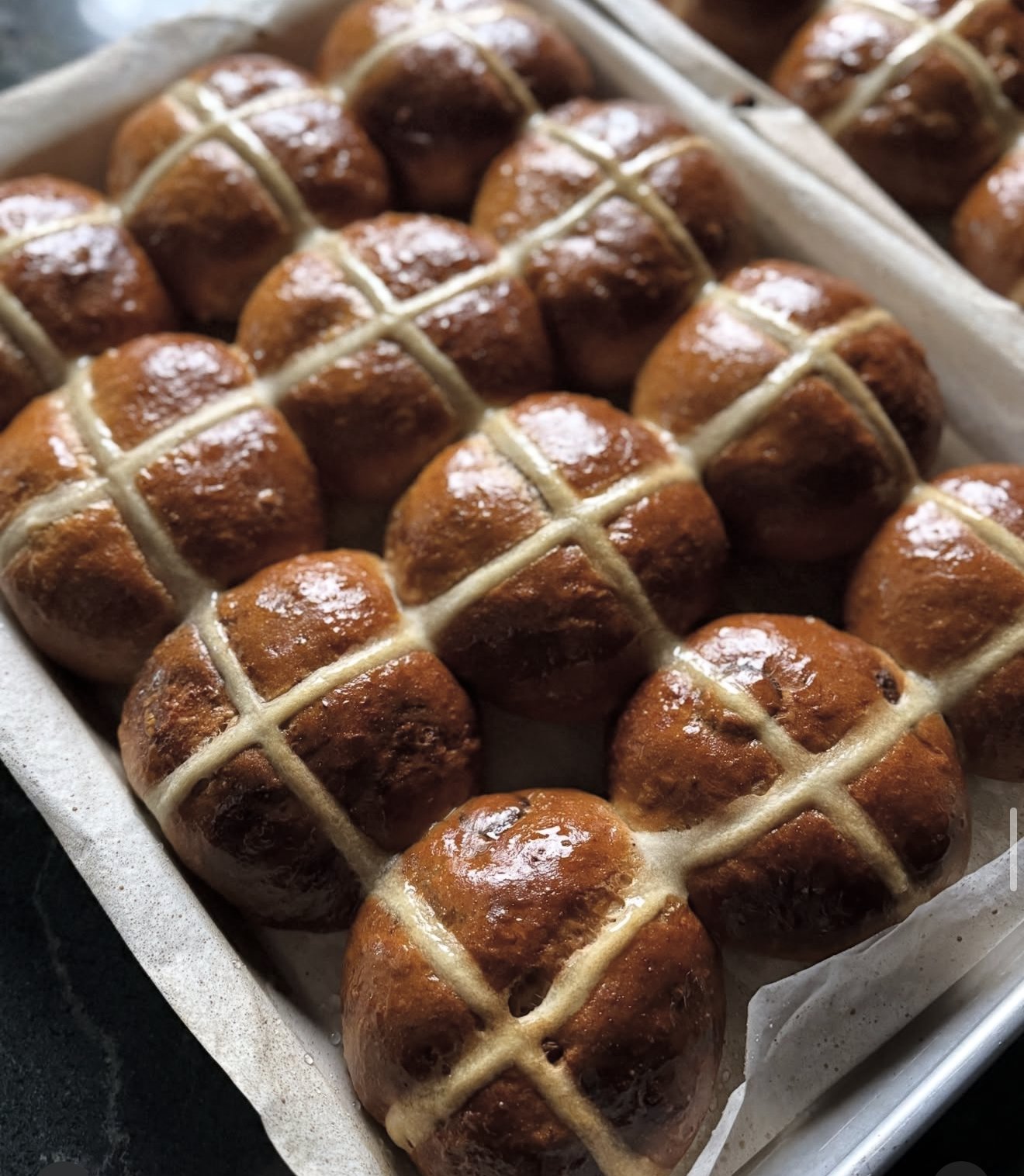 Glazed hot cross buns on a tray
